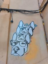 Street art: three stacked faces of a dog.