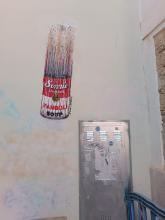 Street art: a Warhol-like can of soup falling down