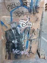 Street art: Trump wearing a face mask and being on a call. Partly destroyed text "Disobey" close to him.