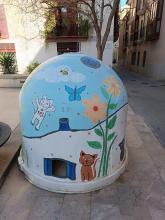 Street art: scene with two cats, a butterfly and a bee on a waste container